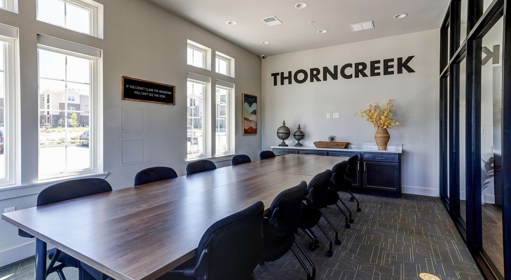 Enjoy our resident-only features a conference room with a large table and chairs