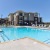 a swimming pool with a building in the background