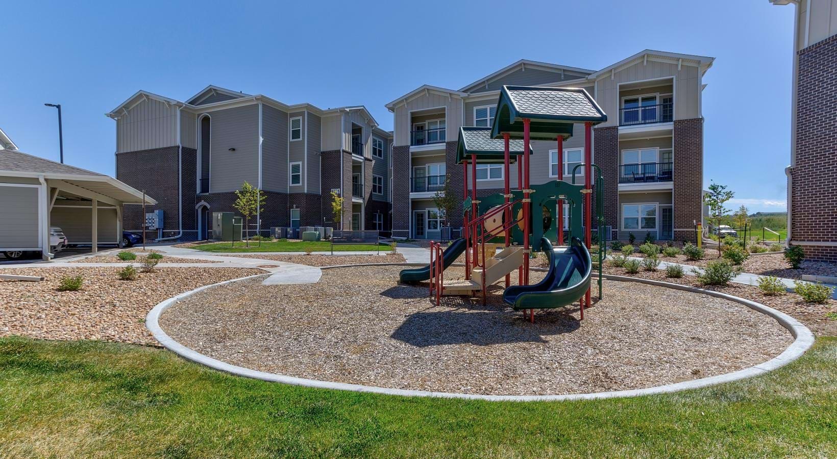 State-of-the-art amenities a playground in front of a building