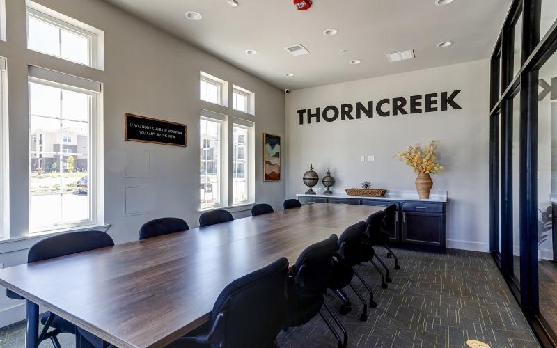 a conference room with a large table and chairs