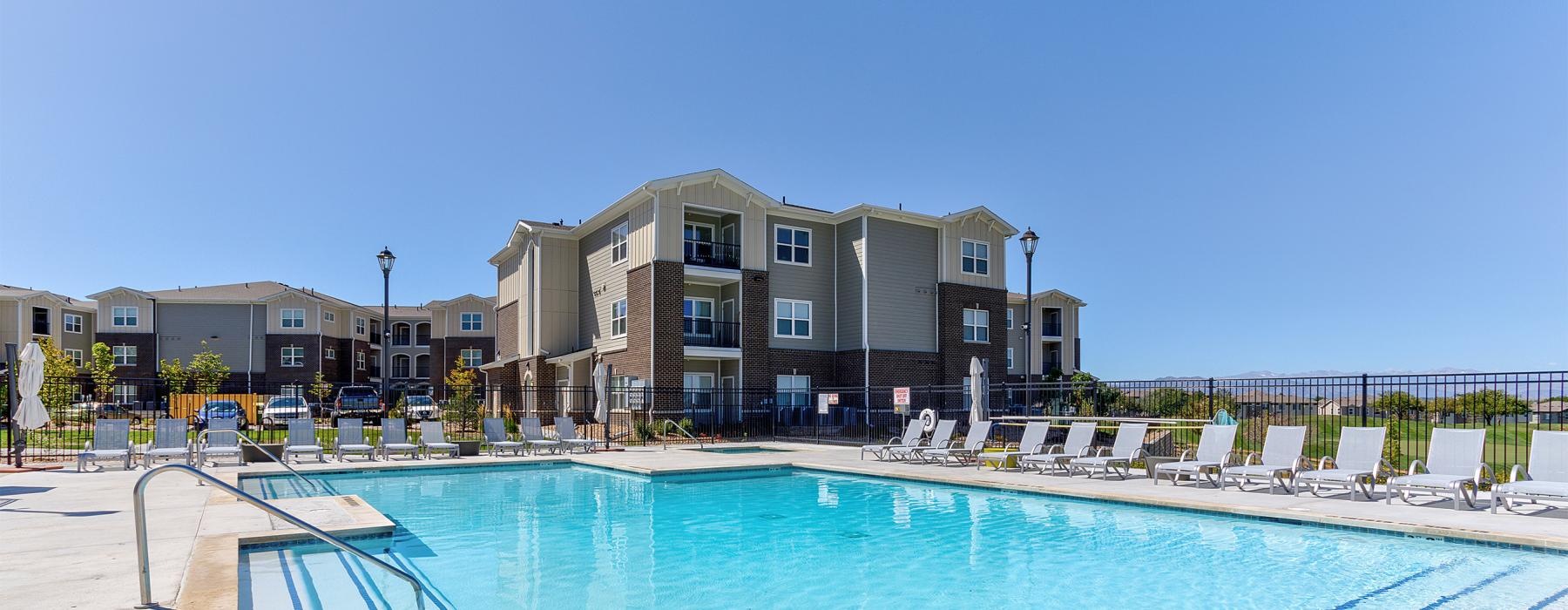 a swimming pool with a building in the background